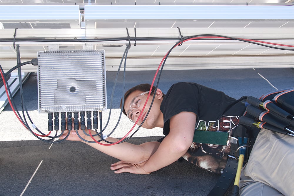 Male student wiring solar panel