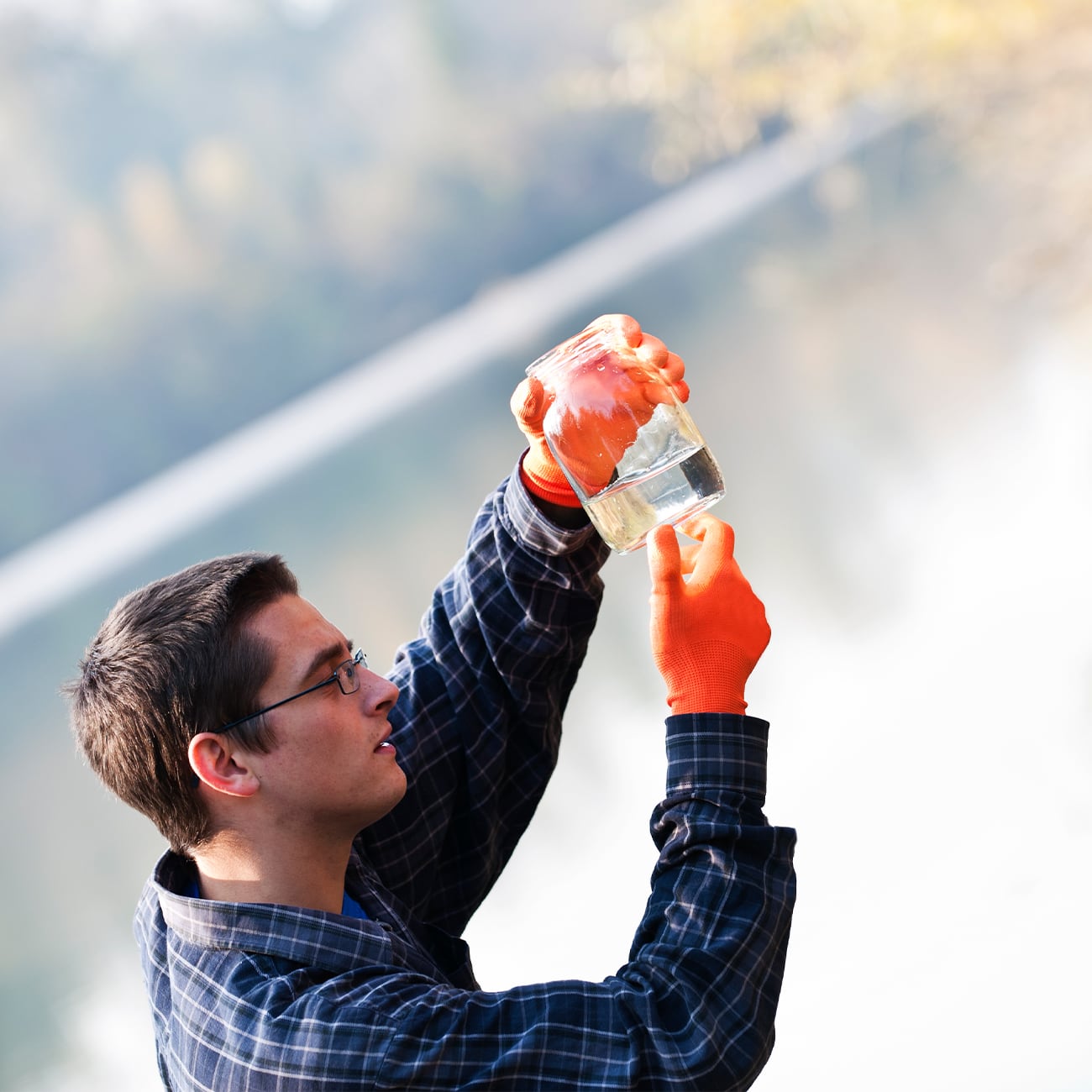 Man taking water sample from lake